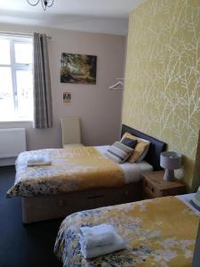 a bedroom with two beds and a window at The Chase Inn in Bishops Frome