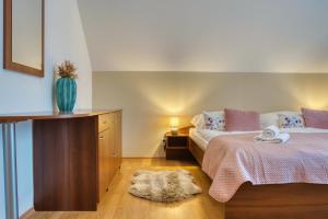 a bedroom with a bed and a vase on the floor at Resort Levočská Dolina in Levoča +57 photos