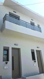a white building with a balcony and a door at Modern Lofts in Archangelos Rhodes with Parking - Equus - 3 Guests in Archangelos