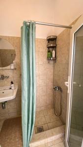 a bathroom with a shower curtain and a sink at Gaia in Agios Georgios