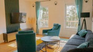 a living room with a couch and two chairs at New Villa Oasis in Imotski