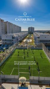 a large field of grass in a city with buildings at Helena Sea Breeze Apartments - Resort Living with Pools & Full Facilities in Kalecik +42 photos
