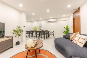 a living room with a couch and a table at The Mellow at Sathorn in Chinatown +21 photos