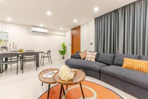 a living room with a couch and a table at The Mellow at Sathorn in Chinatown