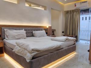 a large bedroom with a large bed with white sheets at Hotel My Soulmate, Palolem Beach in Palolem
