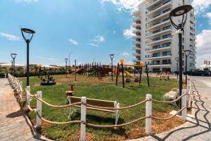 a park with a playground in a city at Helena Sea Breeze Apartments - Resort Living with Pools & Full Facilities in Kalecik