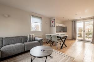 a living room with a couch and a table at Admiralty Lane - No 4 in Elie