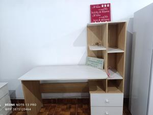 a desk with a book shelf in a room at Los Horneros Zamba in Cerrillos +4 photos