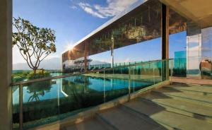 a house with glass walls and a swimming pool at Deluxe 2-Bedroom Suite with Pool & Gym in Chiang Mai