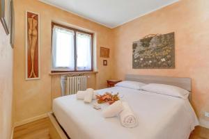 a bedroom with a white bed with towels on it at Rochebrune Apartments in Ski Resort in Claviere
