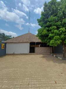 a building with a tree in front of it at AP Luxury Inn in Idowu