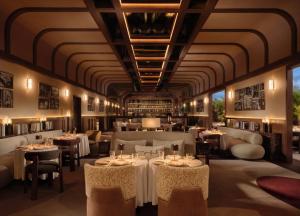 a dining room with tables and chairs and ceilings at Villa Sahrai, a Member of Design Hotels in Casablanca