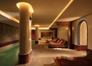a hotel lobby with a pool and a row of chairs at Villa Sahrai, a Member of Design Hotels in Casablanca