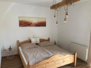 a bed in a bedroom with a picture on the wall at Einzigartig in Kuchl
