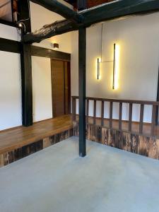 an empty room with two lights on the wall at The Kominka-house Olive in Sano +9 photos