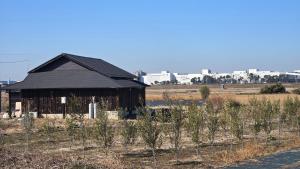 an old barn in the middle of a field at The Kominka-house Olive in Sano
