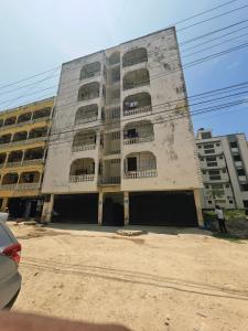 a large building with many windows on the side of it at Mokaya Investments in Mombasa