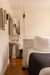 a bedroom with a bed and a sink and a lamp at Le Pigalle, a Member of Design Hotels in Paris +87 photos