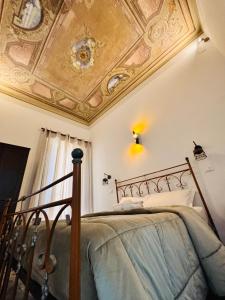 a bedroom with a bed with a coffered ceiling at Calvino Home in Trapani