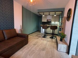 a living room with a couch and a table at The 8 in Lunéville
