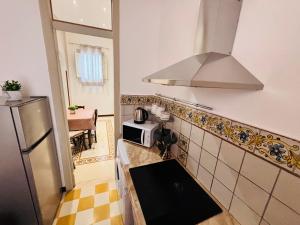 a kitchen with a stove and a microwave at Calvino Home in Trapani