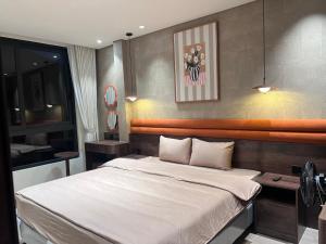 a bedroom with a large bed with white sheets at Moon Inn Apartment-self check in in Hanoi