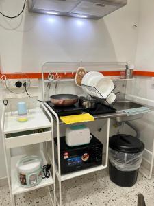 a kitchen with a counter with dishes on it at Puzzle House in Taiping +29 photos