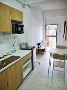 a kitchen with a counter and a table in a room at 57 hua hin in Hua Hin