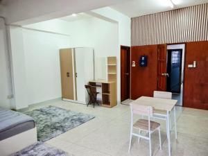 a room with a table and chairs and a desk at 57 hua hin in Hua Hin