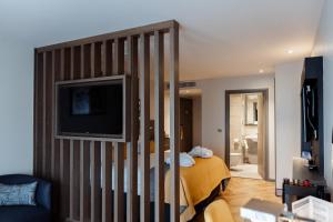 a bedroom with a bed and a tv in a room at Maldron Hotel Newcastle in Newcastle upon Tyne