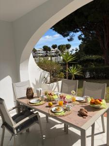 a wooden table with food on it on a patio at Luxury Villa Mijas Costa with Sea View in Mijas Costa