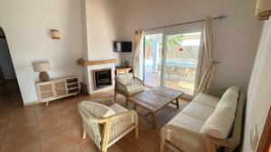 a living room with a couch and a fireplace at 6 person house with private pool and garden in Trebeluger