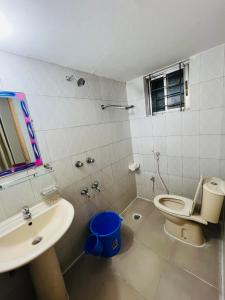 a bathroom with a toilet and a sink at Tourist Home in Ābdullāpur