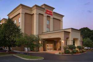 a hotel building with a sign on top of it at Hampton Inn & Suites Greenfield in Greenfield