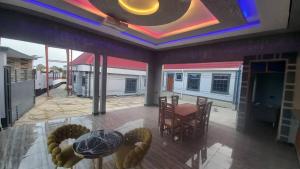 a room with a table and chairs and a ceiling at Ufipa Highland's Hotel in Sumbawanga