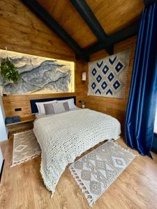 a bedroom with a large bed in a room at Шале Ротило in Krivopolʼye