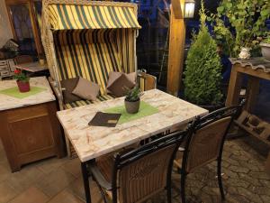 a table with two chairs and a table with plants on it at Landgasthof Zur Post in Zilshausen +25 photos