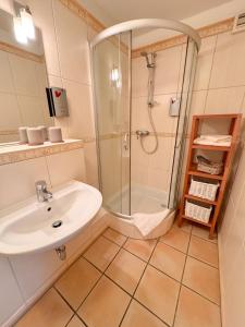 a bathroom with a sink and a shower at Beauty Concept SPA in Lübeck +18 photos