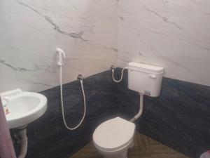 a bathroom with a toilet and a sink at DS Mahal in Pasumalai