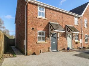an example of a brick house with a driveway at 42 Ynys Y Nos in Neath