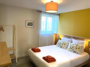 a bedroom with a bed with two towels on it at Grain d'orge et cornouiller in Bulson +45 photos