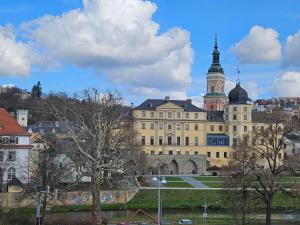 a large building with a tower on top of it at Hotel Friedensbruecke in Greiz