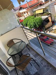 a chair sitting on top of a balcony at 48 Downtown Lofts in Nea Peramos