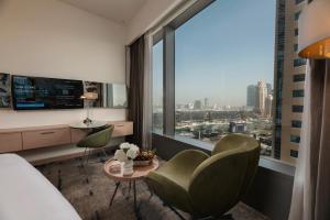 a hotel room with a view of a city at Media One Hotel Dubai, WorldHotels Crafted in Dubai