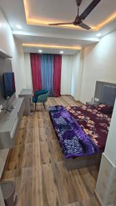 a room with a bed and a desk and a chair at The R B Tower in Unnāo