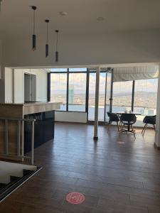 a kitchen and dining room with a table and chairs at Hotel Vista in Tbilisi City