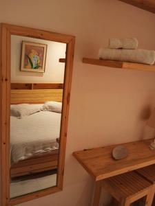 a mirror in a room with a bed at Jardin de bougainvillier in Sfax