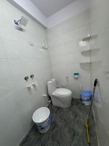 a bathroom with a toilet and a sink in it at Sukoon Stays in Noida
