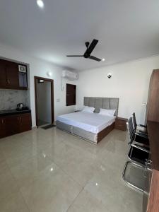 a bedroom with a bed and a ceiling fan at Sukoon Stays in Noida +2 photos