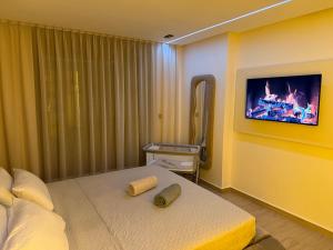 a bedroom with a bed and a tv on a wall at Luxe Appartement Haut Standing Nador Lagoon Rif in Nador